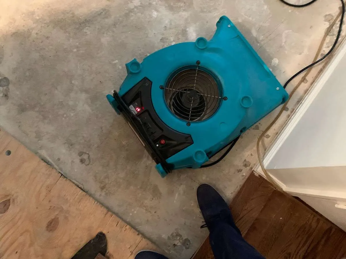 Air mover drying subfloor during Commercial Water Damage Restoration in Kansas City